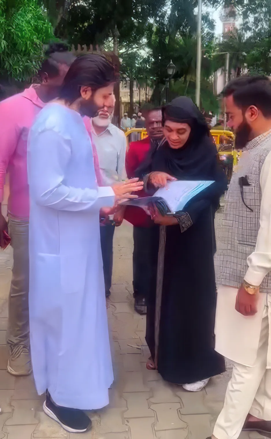 Salmaan Ahmed distributing aid to a woman