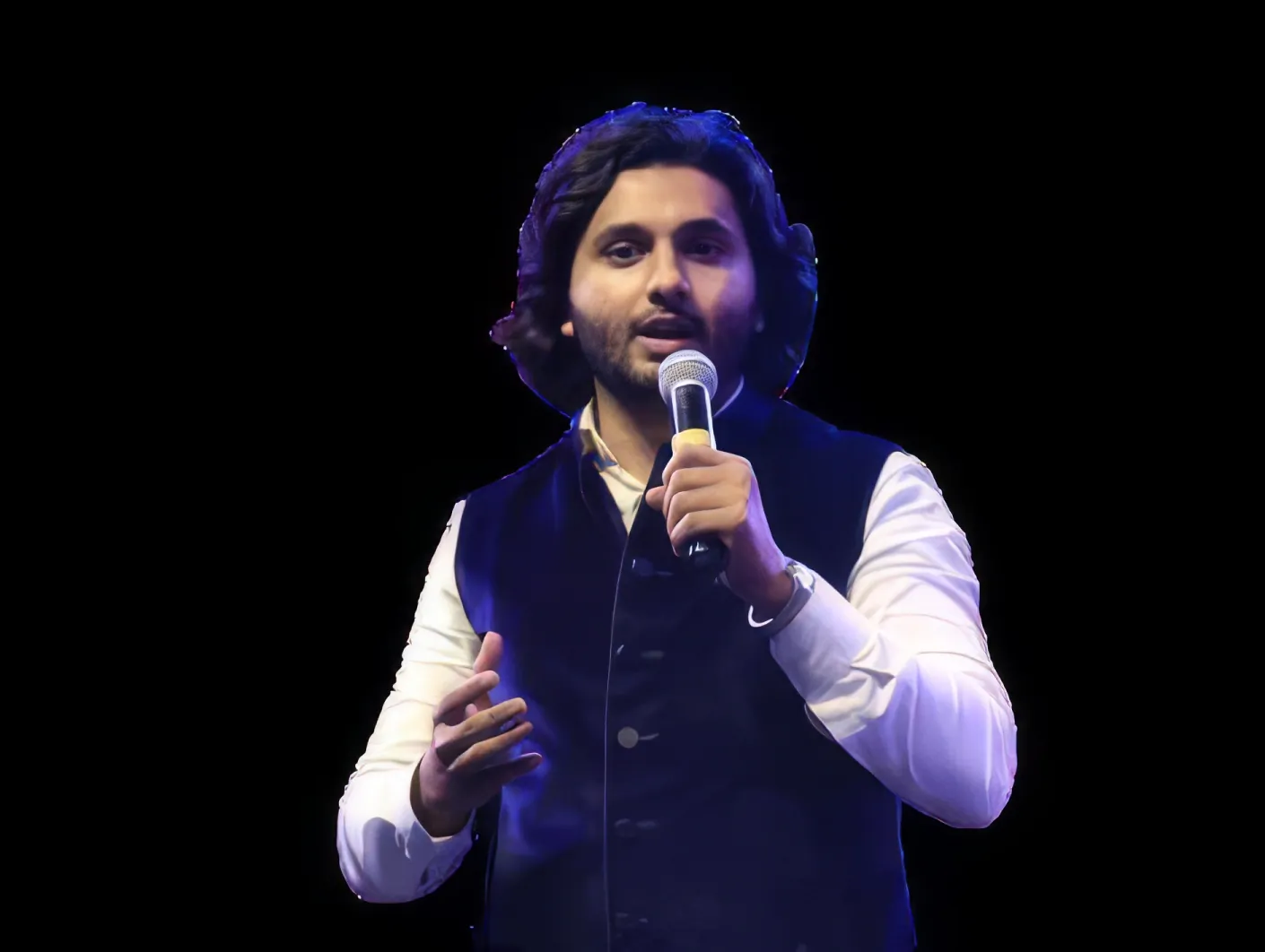 Salmaan Ahmed addressing an audience on stage